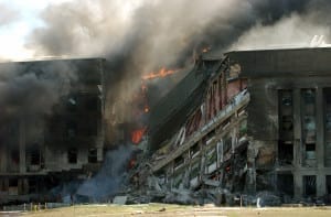 Firefighters work to put out the flames moments after a hijacked jetliner crashed into the Pentagon at approximately 0930 on September 11, 2001.